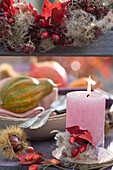 Detail von Holzleiter als Etagere: Kerze auf Holzscheibe, dekoriert mit Hagebutten, Clematisfruchtstand und Herbstlaub, Marone und Kürbis auf Schalen