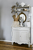 Shabby-chic, vintage-style decorations on shelves and old cabinet