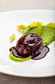 Oeuf Meurette - poached egg in red wine sauce on leek puree