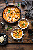 Baked gnocchi with cheese and fresh basil