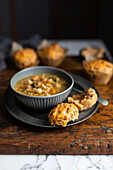 Bowl of vegtable soup with cheese muffin