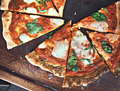 Gluten-free Pizza Margherita cut into pieces