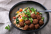 Vegan mini meatballs made with pea protein served with vegetable fried rice