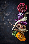 Winter vegetables and pomegranate on a dark background