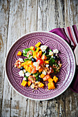 Pumpkin salad with cherry tomatoes, olives and feta cheese