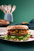 Wholemeal bagel with vegan pattie, lettuce and paprika-corn salsa
