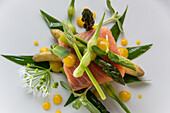 Poached salmon with green asparagus and wild garlic