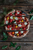 Home made pizza with cherrytomatoes and mini-mozzarella