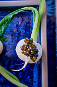 Caviar on white turnip
