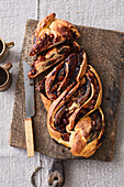Nougat-poppy seed plait with marzipan and plums