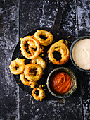 Onion rings in beer batter with malt mayo and pepper ketchup