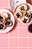Blueberry and honey cream cheese mini tarts with almond flakes
