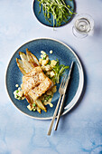 Fried skrei with peas on caramelised chicory
