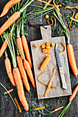 Organic carrots with wooden chopping board and knife
