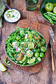 Falafel salad with green peas and green tomatoes