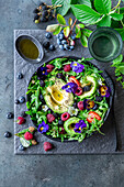 Avocado berry salad with edible flowers
