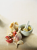 Garlic crushed by pestle in mortar