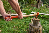 Splitting wood with axe