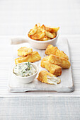 Polenta covered fish fingers, chunky chips and tartar sauce