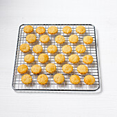 Baked parmesan shortbread canape bases on cooling rack