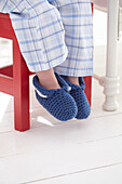Boy wearing crocheted slippers