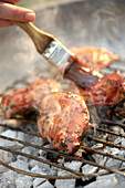 Glazing pheasant breasts on barbeque grill