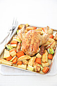 Tray of roast chicken, potatoes, parsnip and carrot