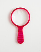 Close-up of pink magnifying glass