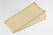 Slice of French beaufort cow's milk cheese