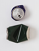 Two crushed drinks cans