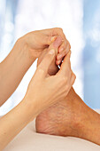 Reflexologist massaging second toe