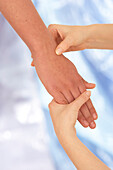 Woman massaging human hand using thumb-walking technique