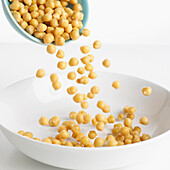 Pouring chickpeas into a bowl