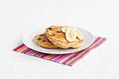 Blueberry pancakes with slices of banana on a plate