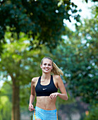 Woman in crop top and shorts running