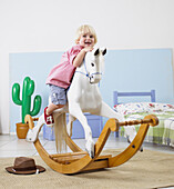 Boy mounting rocking horse