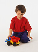 Boy playing with a toy truck