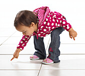 Toddler girl pointing at floor