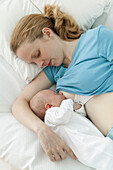 Mother lying down breastfeeding baby