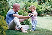 Father in garden playing with his daughter