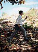Man jogging through woodland area