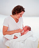 Woman drying baby with towel