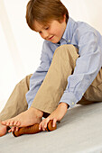 Boy using foot roller