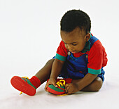 Toddler putting on shoes