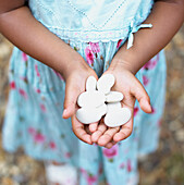 Girl holding oval pebbles