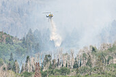 Firefighters dropping water on a wildfire, Utah, USA