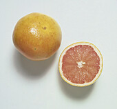 Whole and halved pink grapefruit