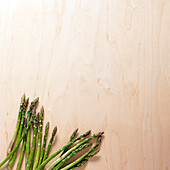 Green asparagus on wooden surface