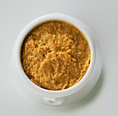 Pot of coarse yellow-brown mustard