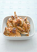 Grilled poussins in bowl